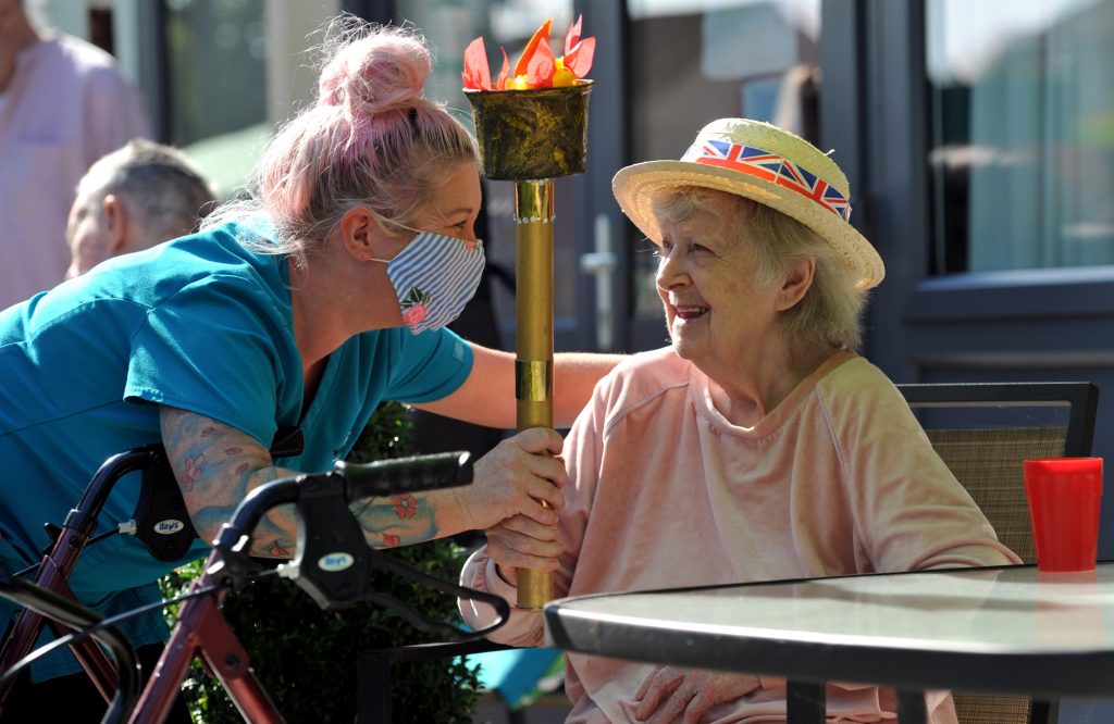 Residents with Dementi fly the Olympic Flag 